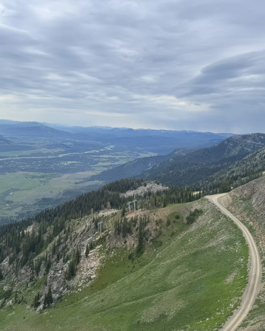 A winding road through green valley hills